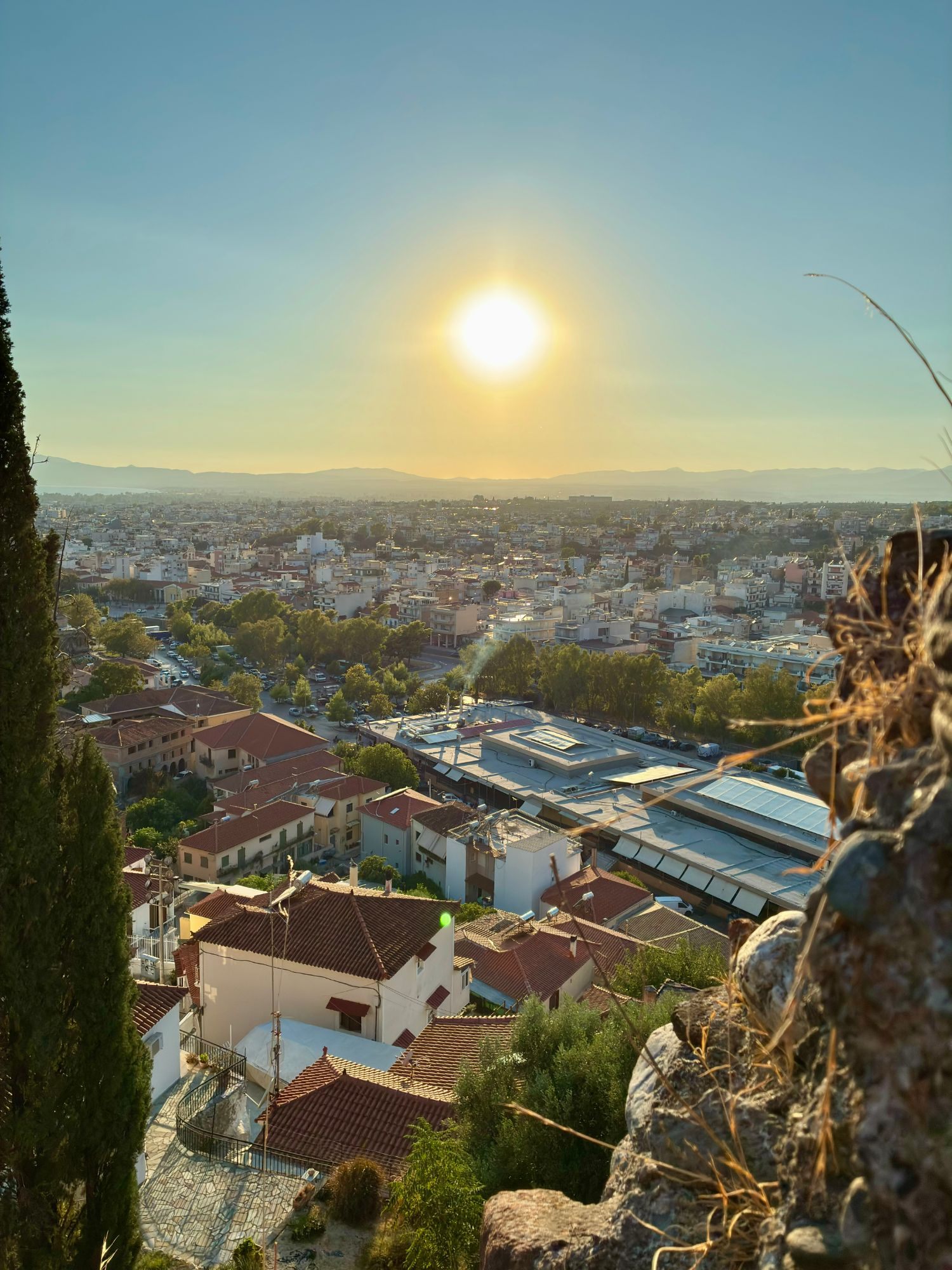 View from Kalamata Castle over the red roofs of the city towards the low sun