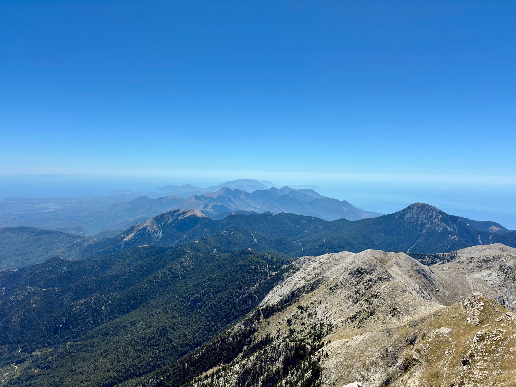 View from the summit of Mount Taygetos over forested ridges and the Mani peninsula towards the sea