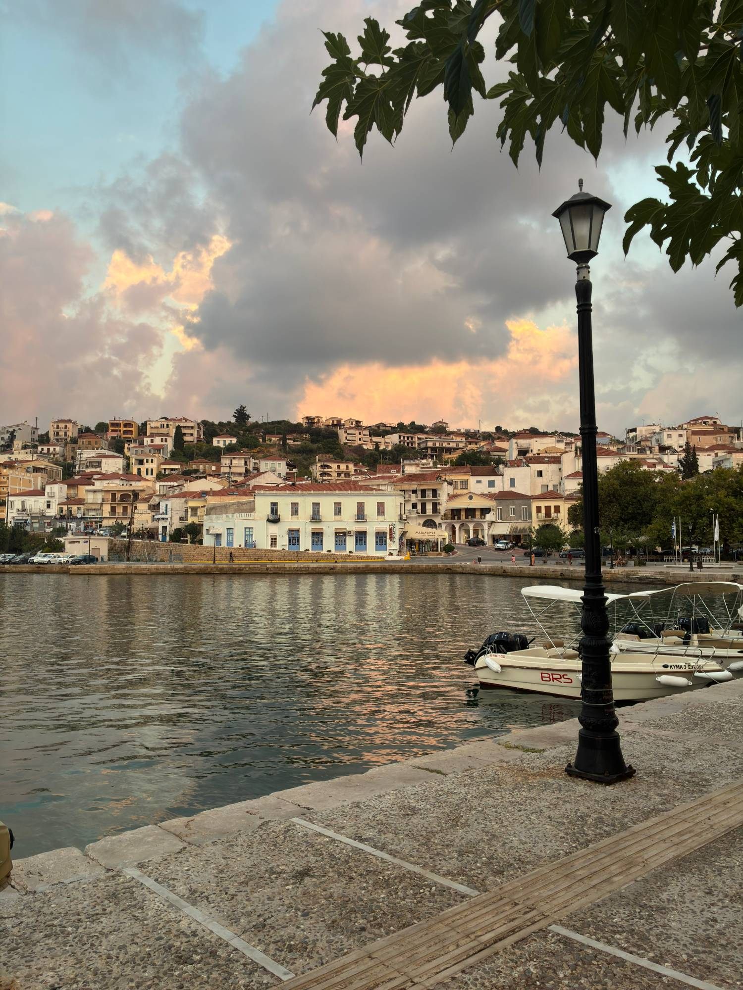Pylos harbour at sunset with pink clouds over the town