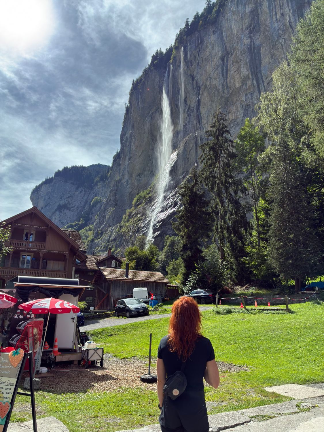 Kristine looking up at Staubbach Falls dropping down the cliff above Lauterbrunnen