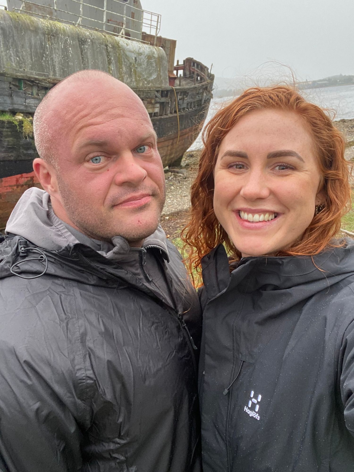 Selfie of Leif and Kristine in rain jackets in front of the Corpach Wreck