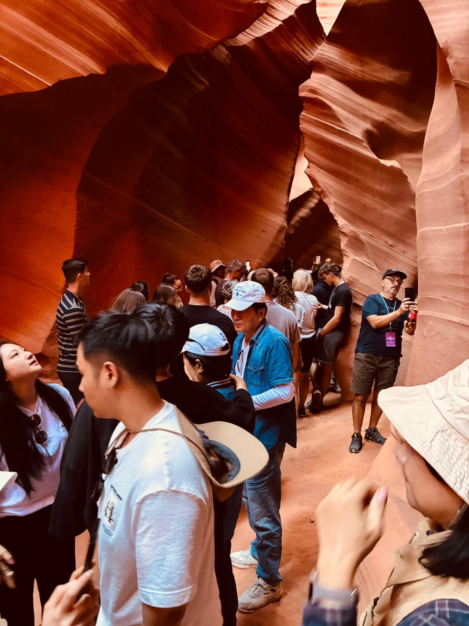 Tour groups packed into a narrow sandstone passage in Lower Antelope Canyon