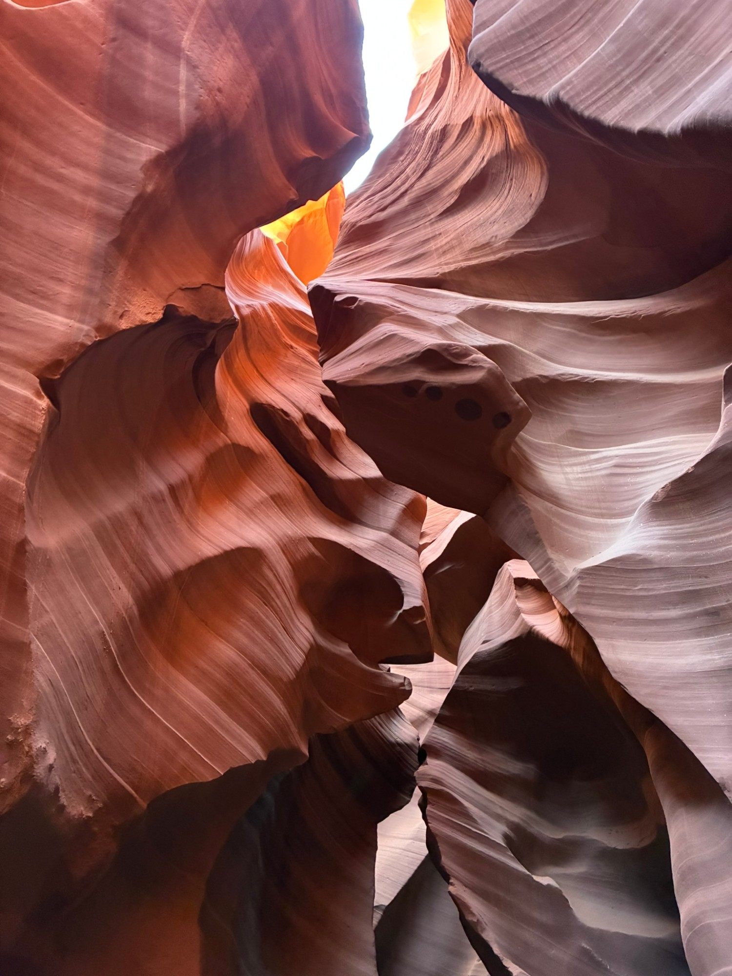 Swirling pink and orange sandstone layers inside Lower Antelope Canyon