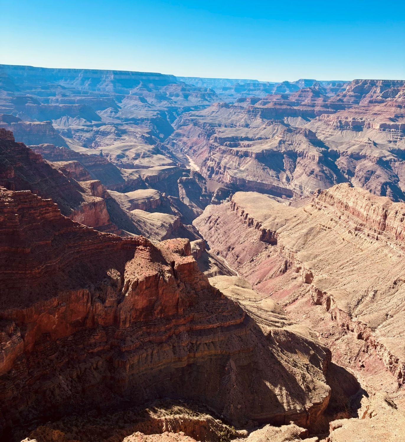 Panoramic view of the Grand Canyon from Lipan Point, with layered red cliffs and the Colorado River far below
