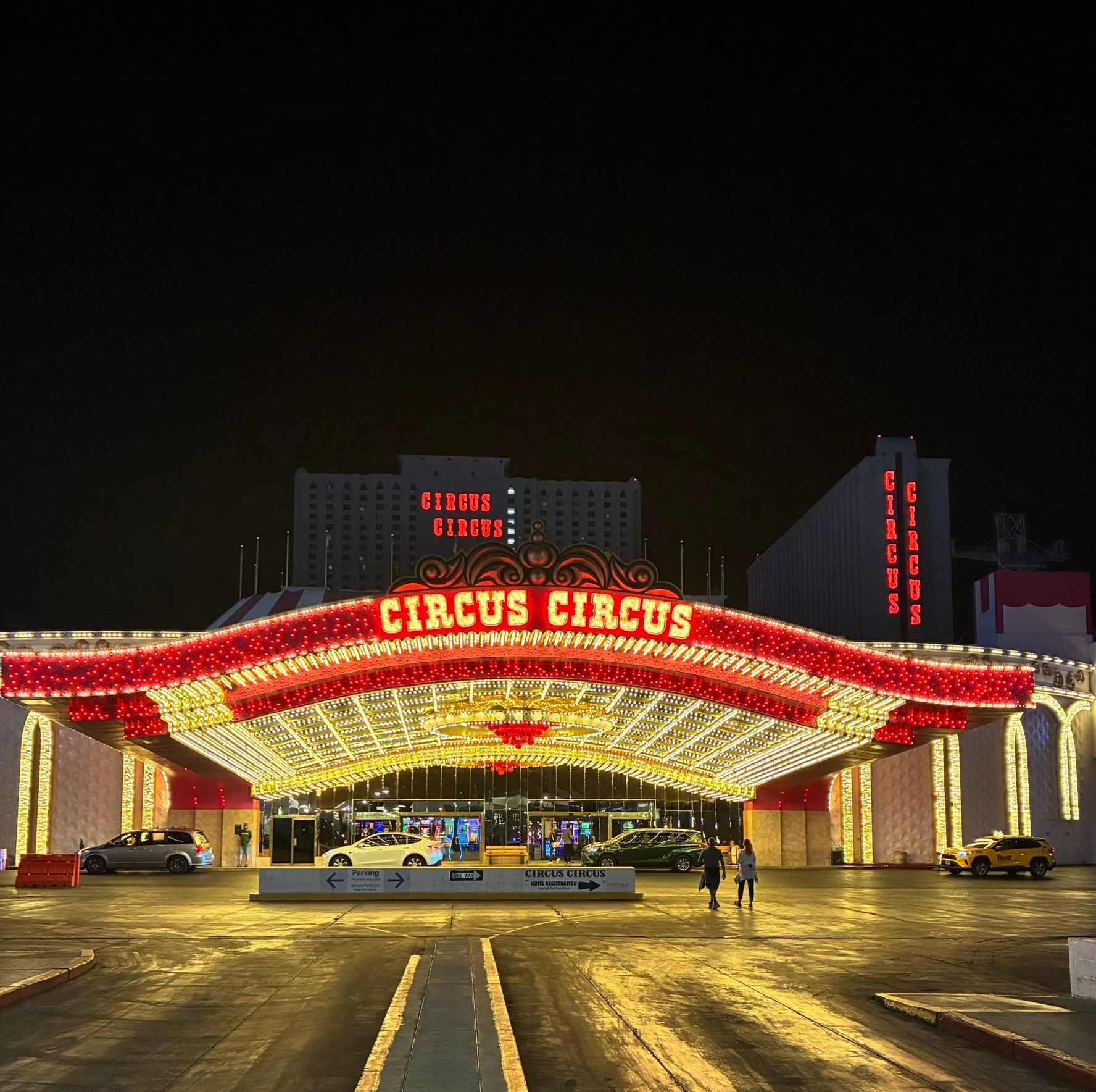 The Circus Circus entrance in Las Vegas at night under a huge canopy of red and gold lights