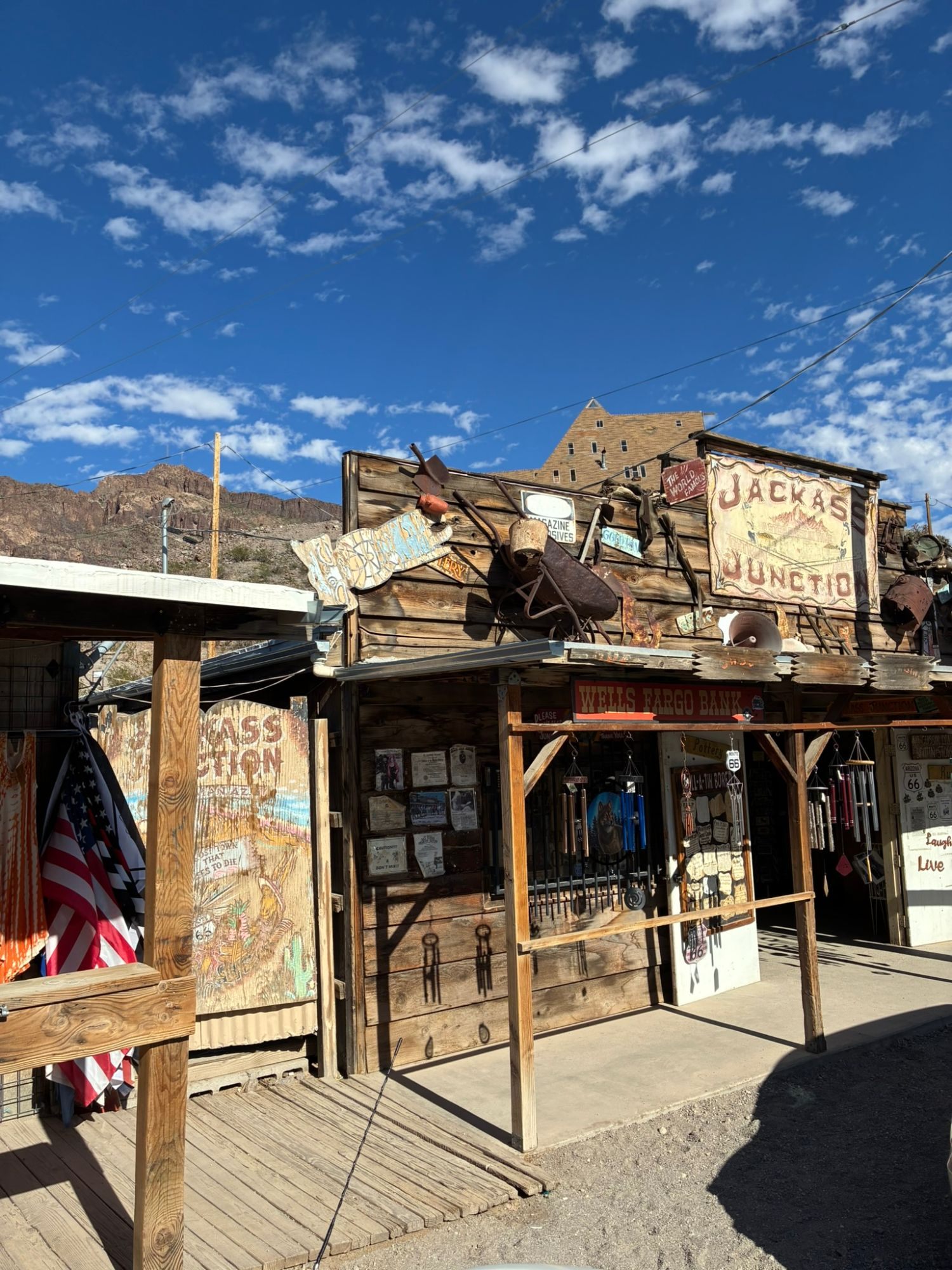 The weathered wooden facade of Jackass Junction, covered in rusty tools and old signs