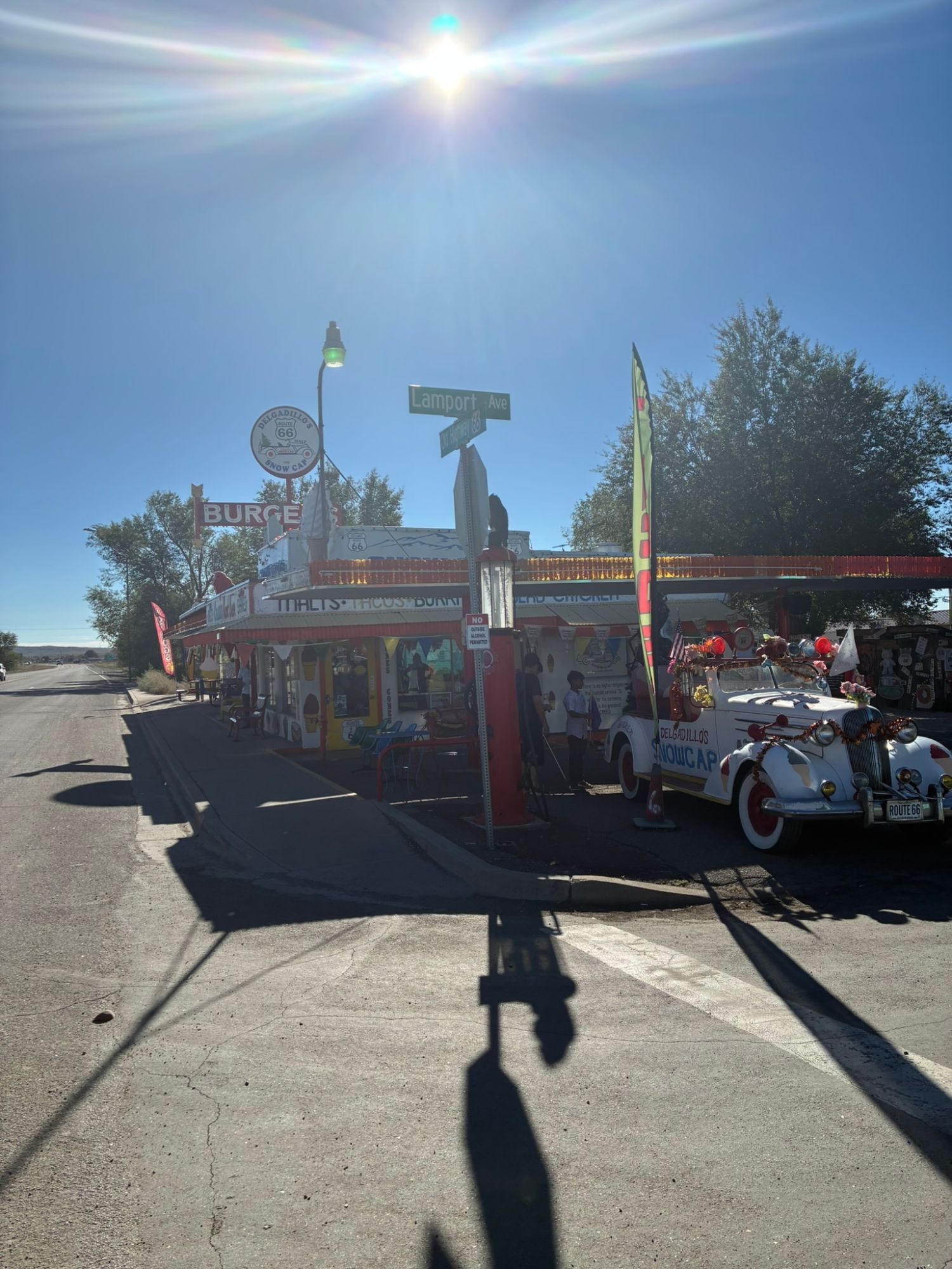 Delgadillo's Snow Cap drive-in in Seligman with its colourful sign, flags and a decorated vintage car, on the corner of Lamport Ave and Old Highway 66