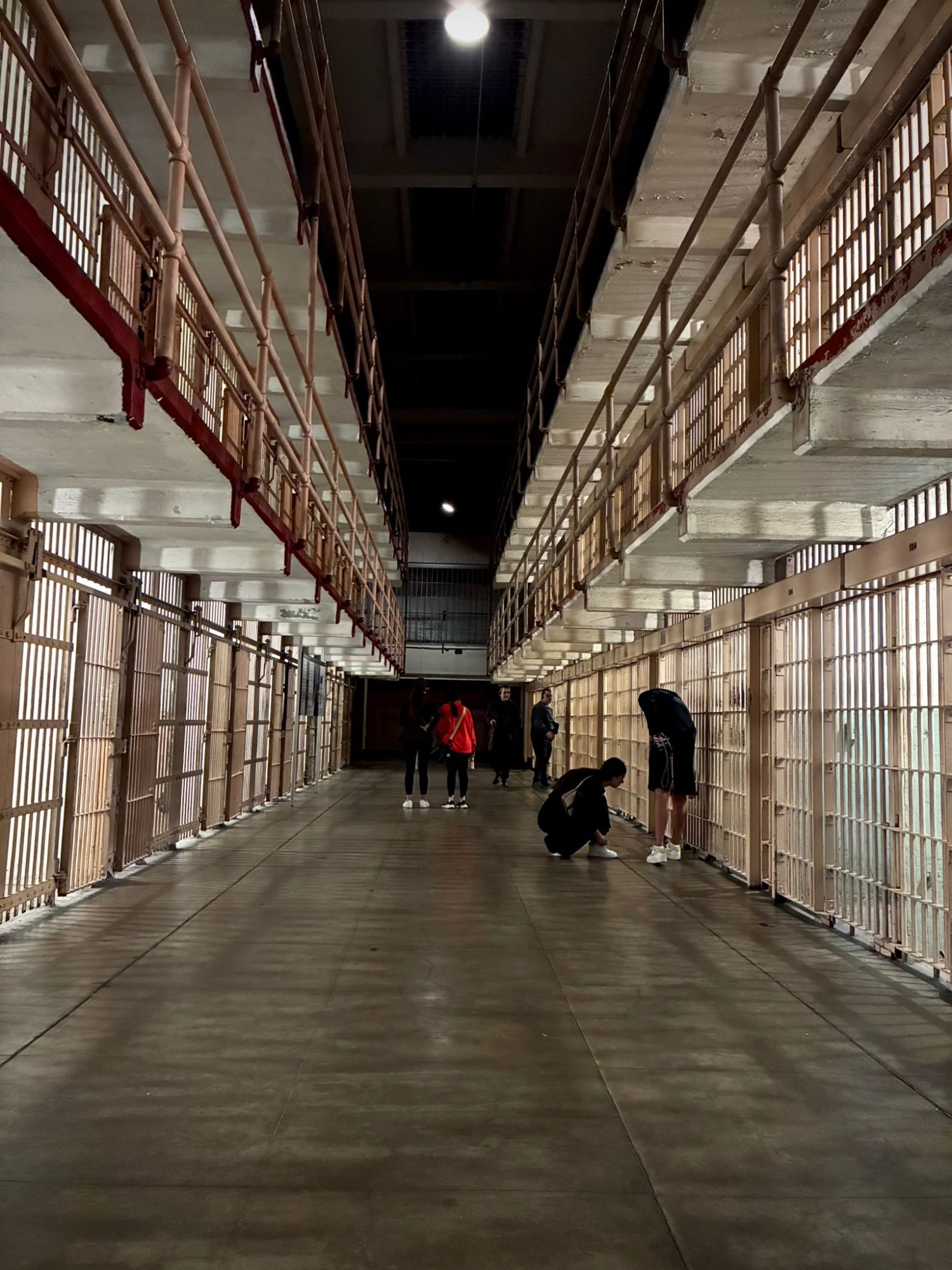 The long cellhouse corridor at Alcatraz with two tiers of barred cells on each side