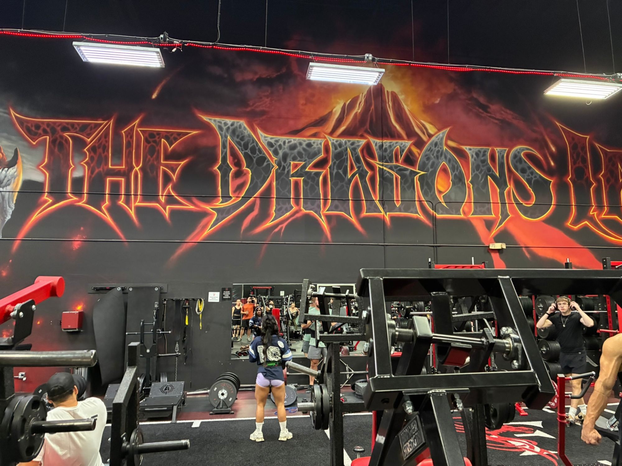 The huge The Dragons Lair mural with a volcano above the lifting platforms and racks