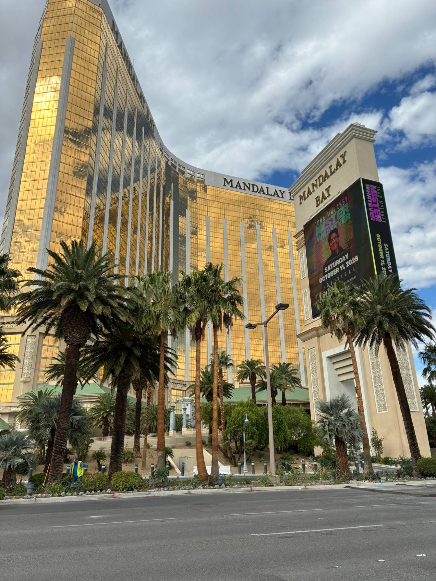 The gold glass towers of Mandalay Bay behind tall palm trees
